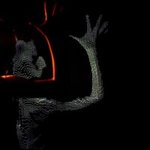 Picture of a dark arm and torso given a light reflection in a black mirror